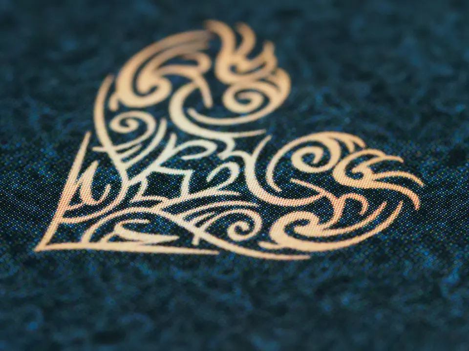 A gold foil pattern printed on a dark blue card.